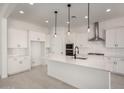 Bright, modern kitchen featuring white cabinets, an island, and stainless steel appliances at 20570 S 216Th Pl, Queen Creek, AZ 85142