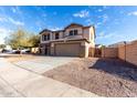 Two-story home with a spacious driveway and xeriscaped front yard for easy maintenance at 25589 W Pleasant Ln, Buckeye, AZ 85326