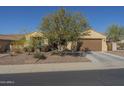 Inviting single-story home featuring desert landscaping and a two-car garage at 25742 N 103Rd Dr, Peoria, AZ 85383