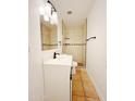 Bright bathroom featuring modern vanity and walk-in shower with decorative tile accents at 2737 W Alice Ave, Phoenix, AZ 85051