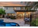 Inviting backyard pool area with covered patio, lounge chairs and lush vegetation at 2744 E Donato Dr, Gilbert, AZ 85298