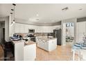 Open kitchen with granite countertops, stainless steel appliances, a center island, and tile flooring at 2829 W Haley Dr, Anthem, AZ 85086