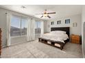 Spacious main bedroom with large windows, neutral tones, carpet, and a ceiling fan at 2829 W Haley Dr, Anthem, AZ 85086