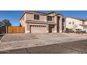 Two-story home featuring a driveway, a two-car garage, and manicured landscaping at 3124 W Redbird Rd, Phoenix, AZ 85083
