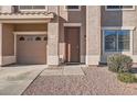 Close up of the front entrance with a two-car garage and neat landscaping at 3124 W Redbird Rd, Phoenix, AZ 85083