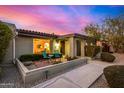 Charming front exterior with sitting area, desert landscaping, and classic architectural features at 3226 E Lazy Ln, Phoenix, AZ 85028