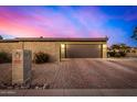 Spacious two-car garage with brick driveway, block wall, and well-maintained landscaping at 3226 E Lazy Ln, Phoenix, AZ 85028