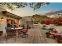 Outdoor patio with dining set, fountain, and mountain views creating a tranquil outdoor space at 3500 E Lincoln Dr # 6, Phoenix, AZ 85018