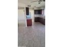 Open kitchen with granite counters, dark wood cabinets and stainless steel appliances at 4124 E Apollo Rd, Phoenix, AZ 85042
