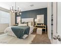 Well-lit main bedroom featuring modern chandelier and geometric accent wall at 48467 N Duran Way, Gold Canyon, AZ 85118