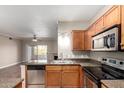 Bright kitchen offers granite counters, stainless appliances, and an open view to the living room at 5345 E Van Buren St # 308, Phoenix, AZ 85008