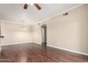 Open living room space features wood floors, a chandelier, and neutral wall paint at 5345 E Van Buren St # 308, Phoenix, AZ 85008