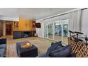 Cozy living room features a fireplace, built-in shelving, and sliding glass doors to the backyard at 5809 W Morten Ave, Glendale, AZ 85301