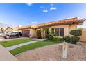 Attractive home featuring manicured landscaping and a driveway with a dark-colored SUV at 607 W Palo Verde St, Gilbert, AZ 85233
