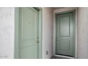 A view of the entrance area of a home, featuring two pale green painted doors at 7649 W Minton St, Laveen, AZ 85339