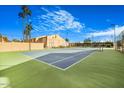 Outdoor tennis court surrounded by trees under a blue sky at Woodland Springs Condominiums at 8055 E Thomas Rd # A102, Scottsdale, AZ 85251