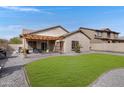 Lush backyard featuring a well-maintained lawn, a desert cactus, and a charming pergola at 10721 W Jefferson St, Avondale, AZ 85323