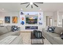 Modern living room with built-in shelving, fireplace, gray sofas, and neutral rug at 11241 N Blakely St, Surprise, AZ 85388
