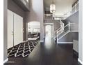 Elegant foyer with dark hardwood floors, staircase with white railing, and views into other living spaces at 12403 W Monte Vista Rd Rd, Avondale, AZ 85392