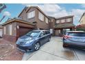 Two-story home featuring a two car garage, shutters, and easy to maintain landscaping at 17641 W Corrine Dr, Surprise, AZ 85388