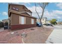 Two-story home featuring shutters, and easy to maintain landscaping at 17641 W Corrine Dr, Surprise, AZ 85388