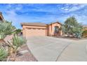 Well-maintained home with a spacious driveway and desert landscaping at 19973 N Monte Ln, Maricopa, AZ 85138