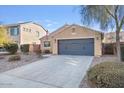 Cozy single-story home featuring neutral stucco, a two-car garage, desert landscaping, and an American flag at 2009 E Lindrick Dr, Gilbert, AZ 85298