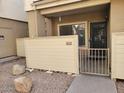 A close up of the entrance to unit 114 featuring private gate and desert landscaping of rocks and pavers at 2035 S Elm St # 114, Tempe, AZ 85282