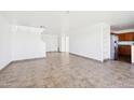 Spacious living room with tile flooring and freshly painted walls and staircase to the left at 22799 W Morning Glory St, Buckeye, AZ 85326