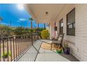 Inviting front porch with outdoor seating, neutral colored decor, and a shaded space for relaxing at 2320 E Harvard St, Phoenix, AZ 85006