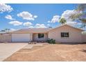 Inviting one-story home featuring a well-maintained lawn and a classic facade on a sunny day at 2359 W Del Oro Cir, Mesa, AZ 85202