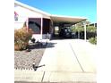 This home features a long driveway leading to a carport, offering ample parking and convenient access at 2400 E Baseline Ave # 58, Apache Junction, AZ 85119