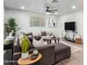 Modern living room with a plush sectional, stylish decor, and plenty of natural light at 2418 W Flower St, Phoenix, AZ 85015