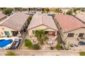 An aerial view of a backyard featuring desert landscaping, a pool, and an outdoor kitchen at 32177 N Echo Canyon Rd, San Tan Valley, AZ 85143