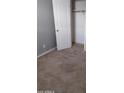 A carpeted bedroom with light gray walls and a closet at 374 S Verdad Ln, Casa Grande, AZ 85194