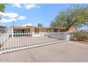 Inviting single-story home with a secure white fence and a convenient covered carport at 416 W Chambers St, Phoenix, AZ 85041