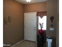 Inviting entryway with tile floors, neutral walls, and decorative accents at 45049 W Cypress Ln, Maricopa, AZ 85139