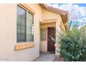 Inviting facade with a front door and trimmed window showcases curb appeal and natural light at 45049 W Cypress Ln, Maricopa, AZ 85139