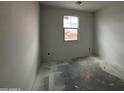 Unfinished bedroom featuring a window offering views of the surrounding construction and neutral walls at 47733 W Kenner Dr, Maricopa, AZ 85139