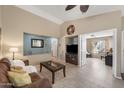 Comfortable living room with tile flooring, ceiling fan, and an open layout to other areas of the home at 48 E Nolana Pl, San Tan Valley, AZ 85143