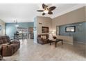 Inviting living room featuring tiled floors, plush seating, and an open layout to the dining area at 48 E Nolana Pl, San Tan Valley, AZ 85143