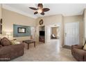 Spacious living room with neutral colors, ceiling fan, tile flooring, and access to additional rooms at 48 E Nolana Pl, San Tan Valley, AZ 85143
