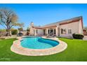 Beautiful backyard featuring a pool, artificial grass, and patio seating, perfect for outdoor living at 4944 E Dale Ln, Cave Creek, AZ 85331