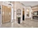 Inviting entryway with tiled floors, a decorative plant, and an archway leading to other rooms at 4944 E Dale Ln, Cave Creek, AZ 85331