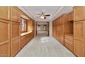 Hallway with custom built-in cabinets and carpet flooring, providing ample storage space at 576 W Moon Valley Dr, Phoenix, AZ 85023