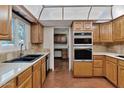 Traditional kitchen with wood cabinets, tile countertops, and stainless steel appliances at 576 W Moon Valley Dr, Phoenix, AZ 85023