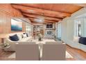 Cozy living room features a stone fireplace, wooden beam ceilings, and comfortable seating arrangements at 576 W Moon Valley Dr, Phoenix, AZ 85023