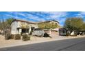 Inviting two-story home with desert landscaping, featuring a convenient two-car garage and covered porch at 5924 W Running Deer Trl, Phoenix, AZ 85083