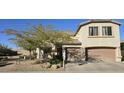 Charming two-story home with a well-manicured, low maintenance front yard and an attached two-car garage at 5924 W Running Deer Trl, Phoenix, AZ 85083