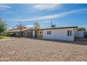 Single-story home with a front yard with gravel landscaping, a carport, and a neutral color scheme at 829 W Mitchell Dr, Phoenix, AZ 85013